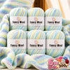 A set of six balls of fancy wool yarn in various pastel gradients for knitting and crochet projects.