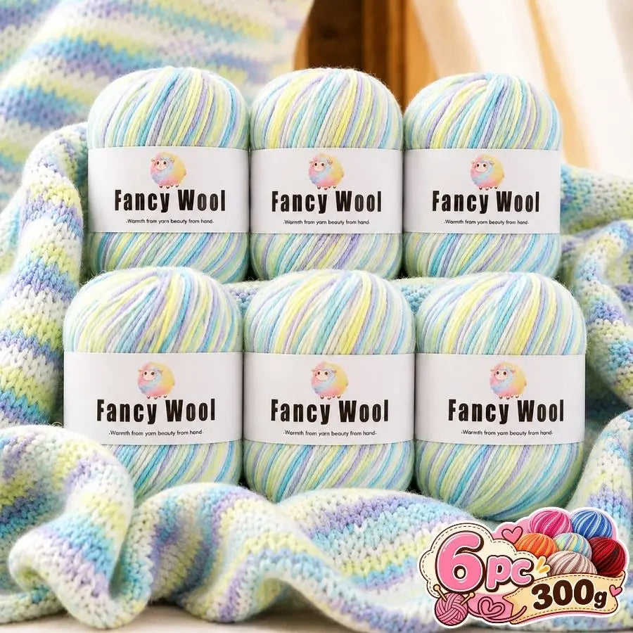 A set of six balls of fancy wool yarn in various pastel gradients for knitting and crochet projects.