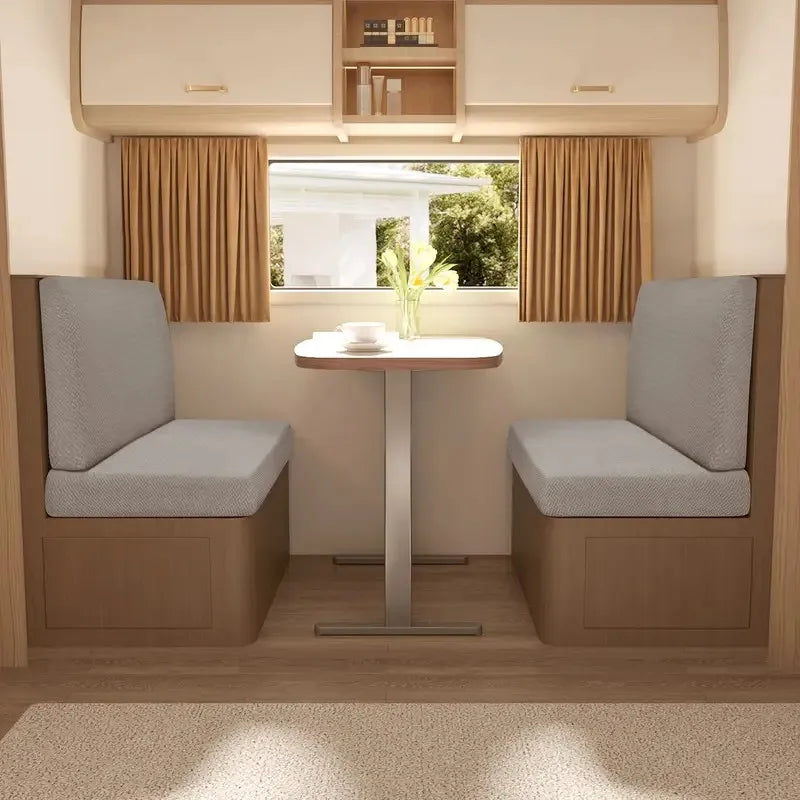 A modern interior showing two upholstered seats with light gray covers and a small table.