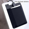 A black adhesive laptop back storage pouch with a flexible cord is shown against a white background.
