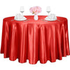 A red satin table overlay set for events featuring glassware and white napkins.