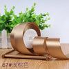 Roll of 4 cm wide satin ribbon in a bronze color with white filler for gift wrapping and crafts