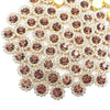 Close-up of sunflower crystal rhinestone sew-on buttons in shades of rose gold and clear stones.