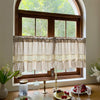 Beige gingham crochet lace curtain valance hanging over a wooden window frame.