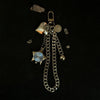 Silver star-shaped pocket watch keychain with a chain and a hanging charm on a black background