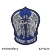 An embroidered patch featuring a winged figure with a sword and halo on a blue background.