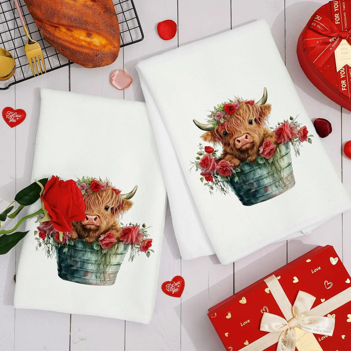 A set of white kitchen towels featuring a watercolor illustration of a pig in a floral bucket.