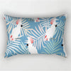 A decorative pillowcase featuring a tropical leaf print pattern in shades of blue and white.
