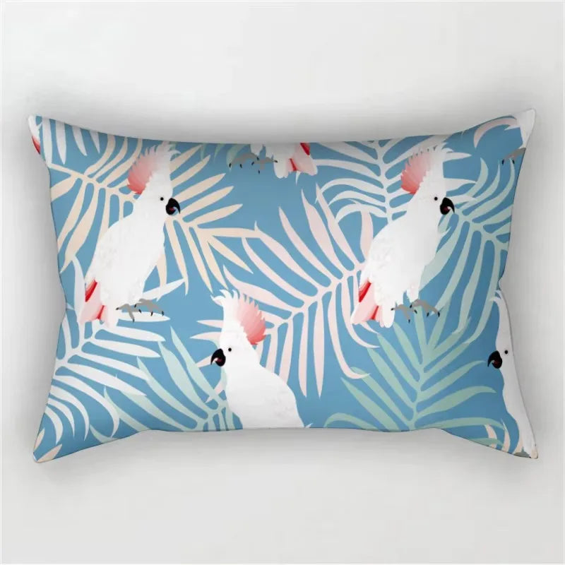 A decorative pillowcase featuring a tropical leaf print pattern in shades of blue and white.