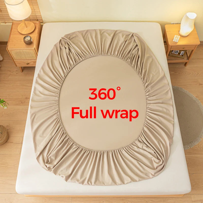 A beige fitted sheet is shown fully wrapped around a mattress, demonstrating a 360 degree coverage.
