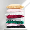 A stack of two ruffled satin pillowcases in pastel and dark colors, including yellow, pink, white, red, green, and black.