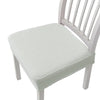 A white wooden dining chair with a removable, quilted light green polyester seat cover.
