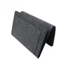 A dark gray felt bedside storage organizer with a hanging pocket.