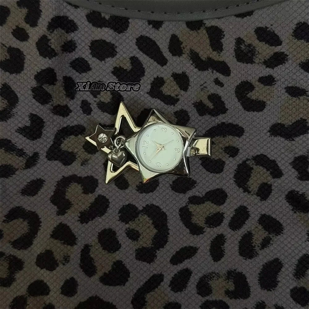 A gold-toned star-shaped pocket watch keychain with an adjustable clock face set against a leopard print background.