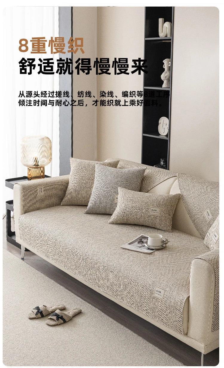 A beige linen sofa cover cushion is displayed on a light-colored sofa with matching pillows.