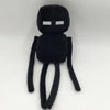 A black stuffed dragon plush toy with white eyes and long limbs.