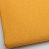 Close-up of a yellow coarse linen and cotton fabric textile.