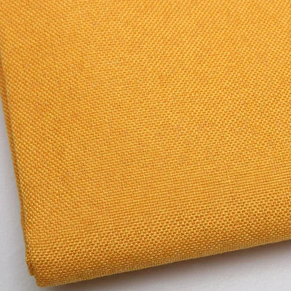 Close-up of a yellow coarse linen and cotton fabric textile.