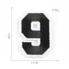 A black felt number 9 patch with white stitching and square cutouts, measuring 3.5 cm by 5 cm.