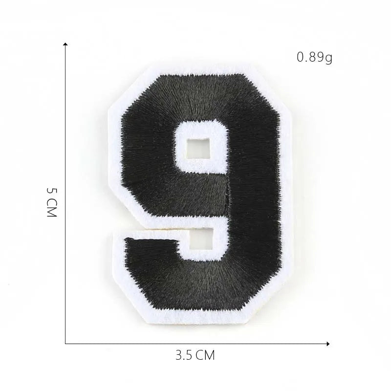 A black felt number 9 patch with white stitching and square cutouts, measuring 3.5 cm by 5 cm.