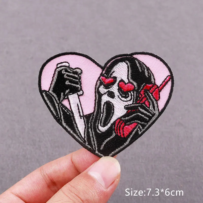 Embroidered horror movie patch featuring a skull with horns and a screaming face on a pink background