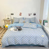 A blue and white checkered duvet cover set displayed on a bed with a light blue headboard and surrounding decor.
