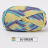 A ball of hand-dyed fabric strip yarn featuring yellow, purple, and blue stripes.