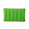 A bright lime green portable inflatable travel pillow with ribbed texture.