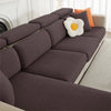A dark gray jacquard elastic sofa cushion slipcover with orange accent pillows on a white sofa.