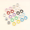 A collection of various colored metal claw buckle clamps arranged in a radial pattern.