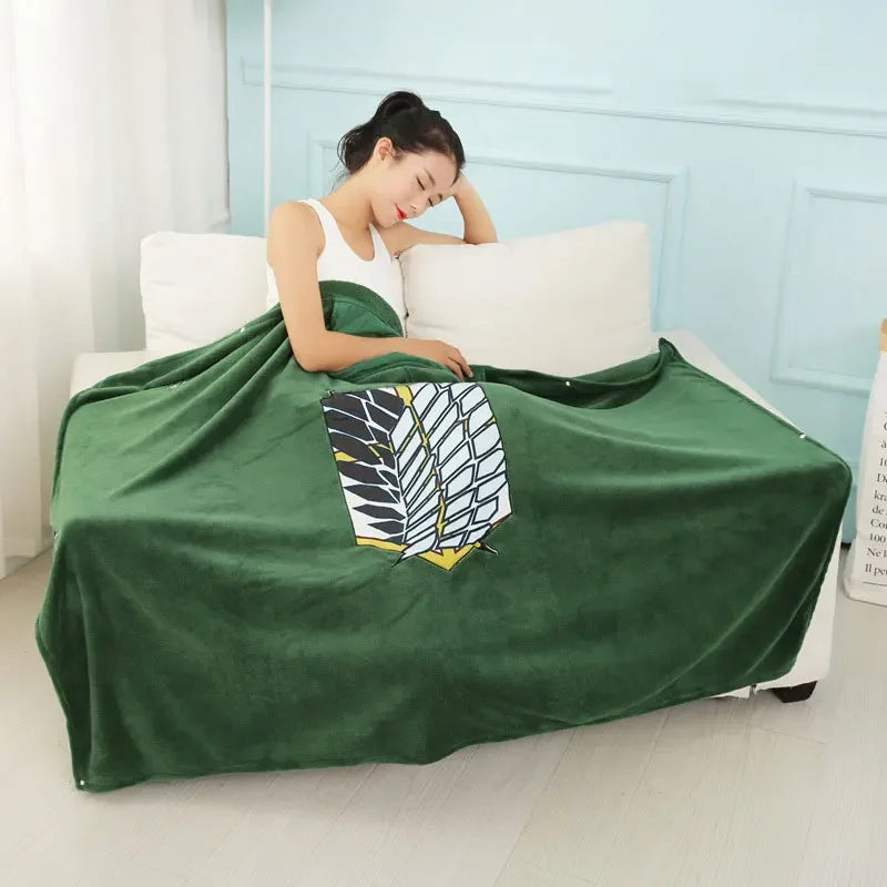 A dark green flannel cloak with a white and black leaf pattern is draped over a white bed.