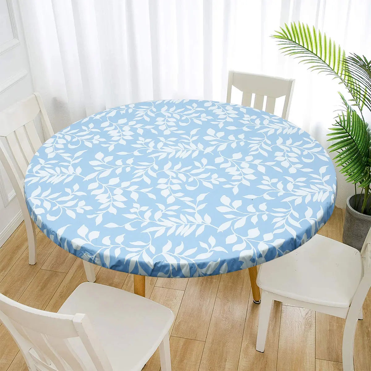 A round light blue vinyl tablecloth set on a wooden table surrounded by white chairs.