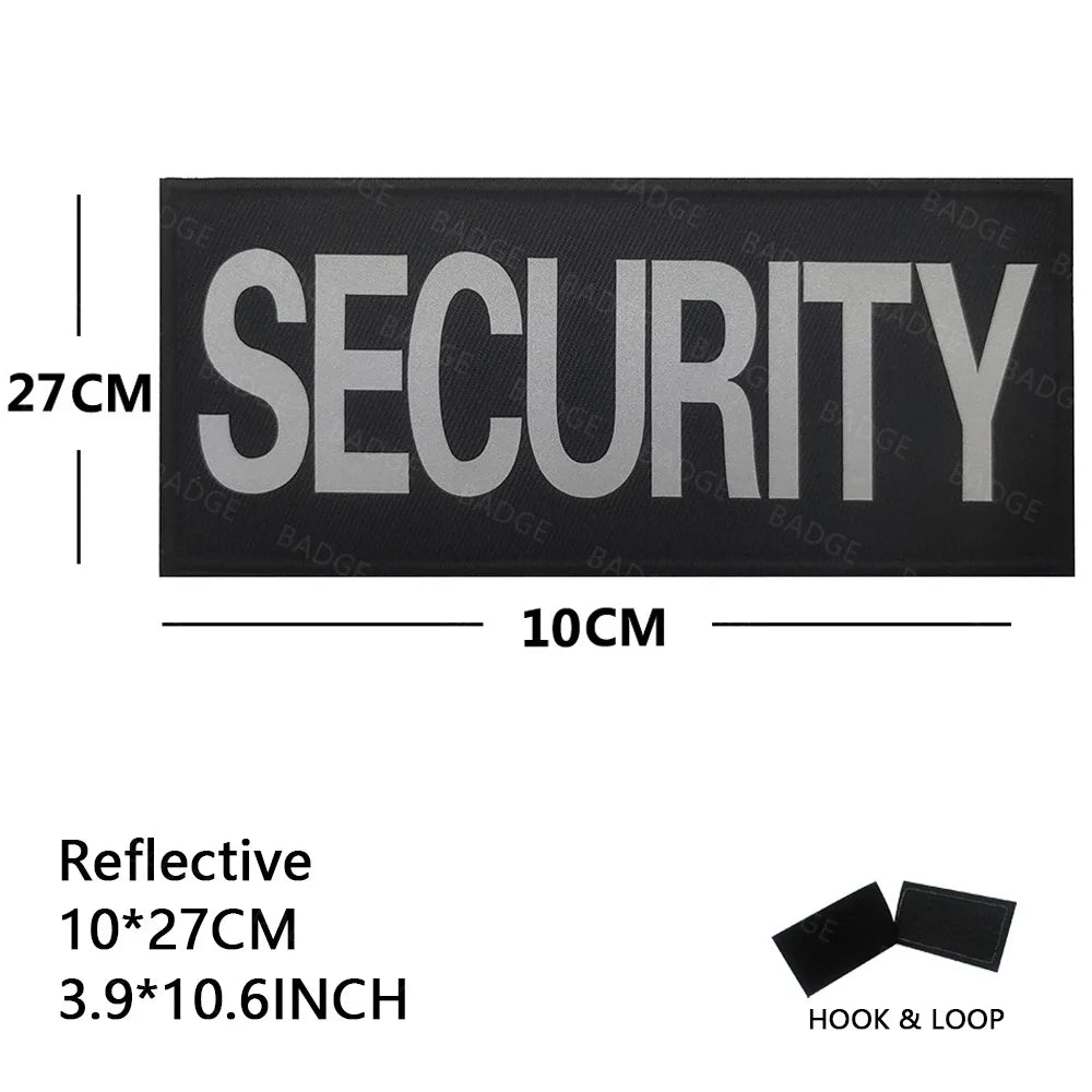 Black reflective security patch measuring 10cm by 27cm with a hook and loop closure