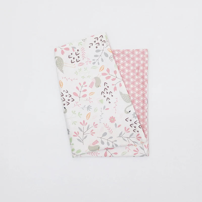 A stack of soft cotton baby pillow covers featuring various floral and animal patterns.
