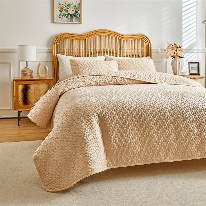 A beige plaid quilt set is displayed on a queen bed with a light wood headboard and neutral bedding.