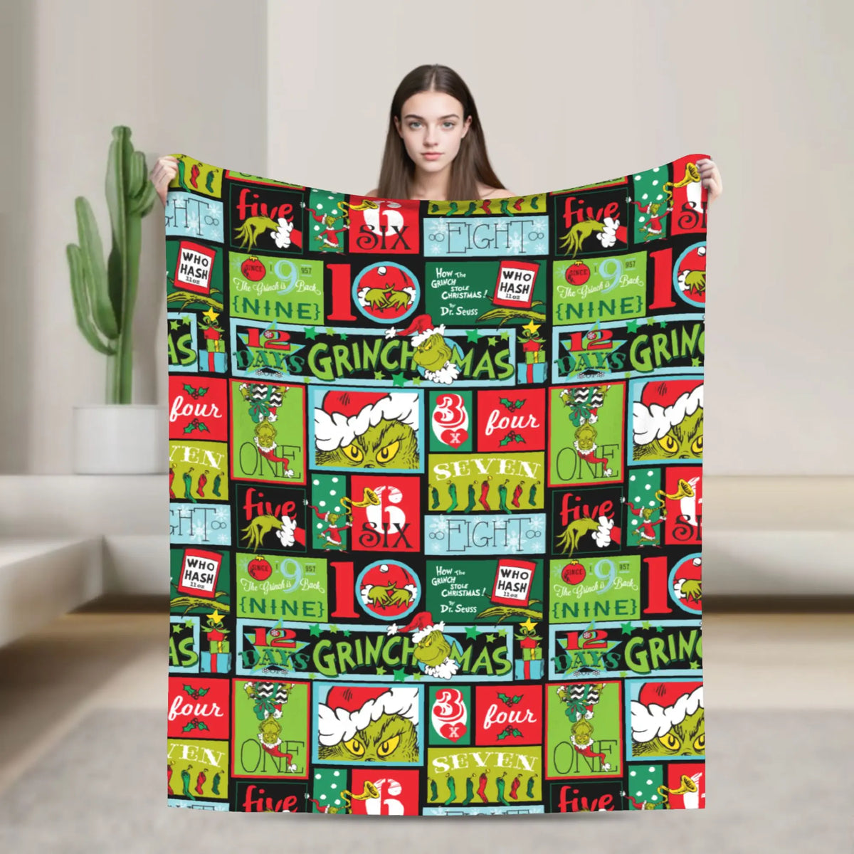 A colorful Christmas themed throw blanket featuring reindeer and festive designs.