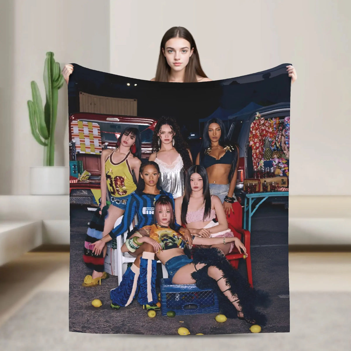 A woman holds up a large print featuring a K-Pop style group with vibrant makeup and clothing.