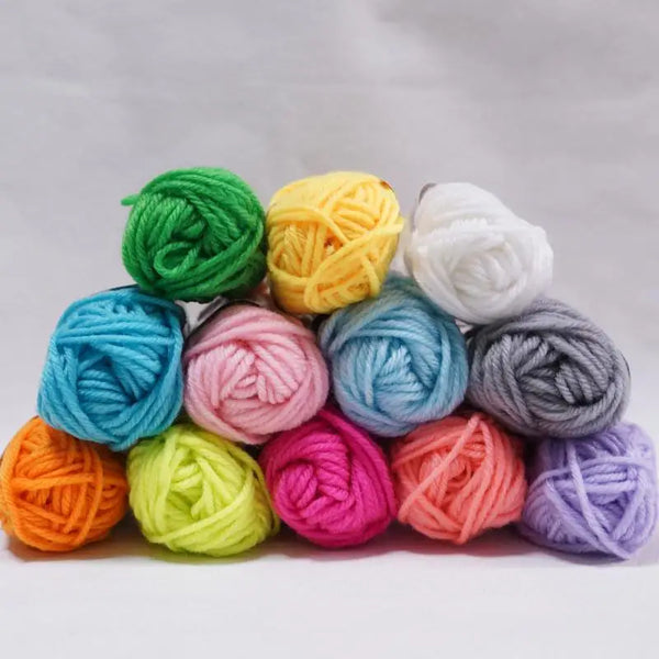 A collection of twelve brightly colored milk cotton yarn skeins arranged in a row.