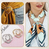 A close-up of elegant metal ring clips used as clothing and accessory fasteners.
