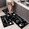 Black floor mat with white illustrations of coffee cups and espresso beans