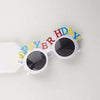 White sunglasses decorated with colorful birthday text on the frame