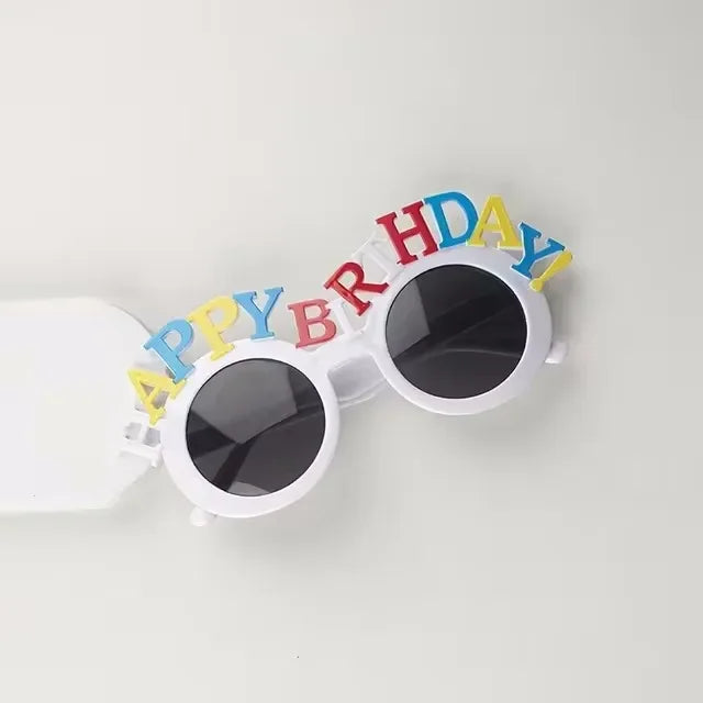 White sunglasses decorated with colorful birthday text on the frame