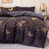 A dark purple duvet cover set featuring a gold butterfly print on a gray bed.