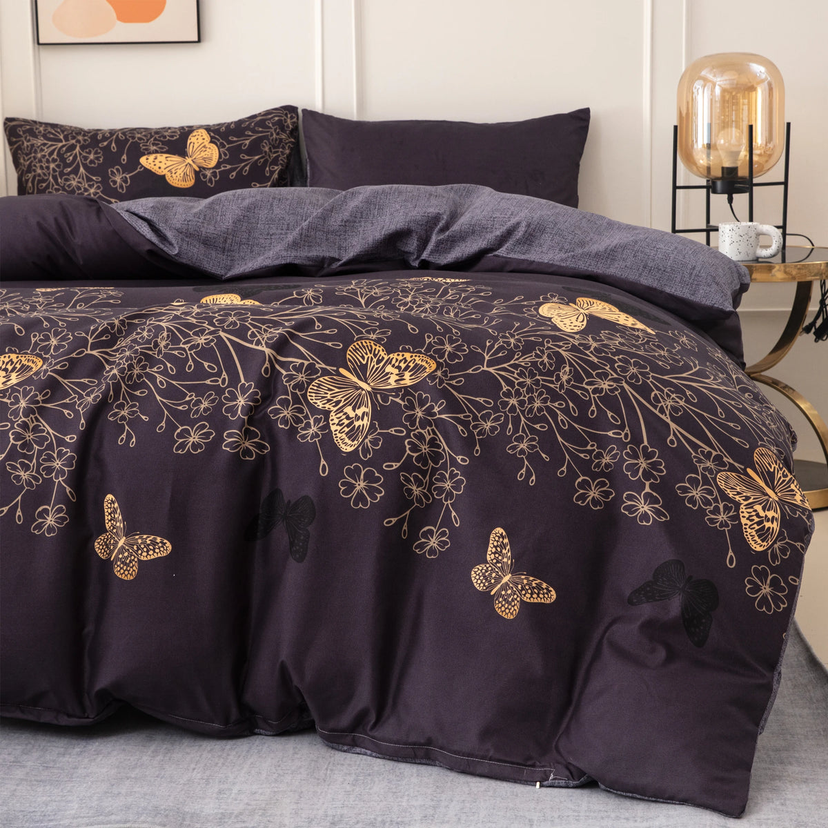 A dark purple duvet cover set featuring a gold butterfly print on a gray bed.