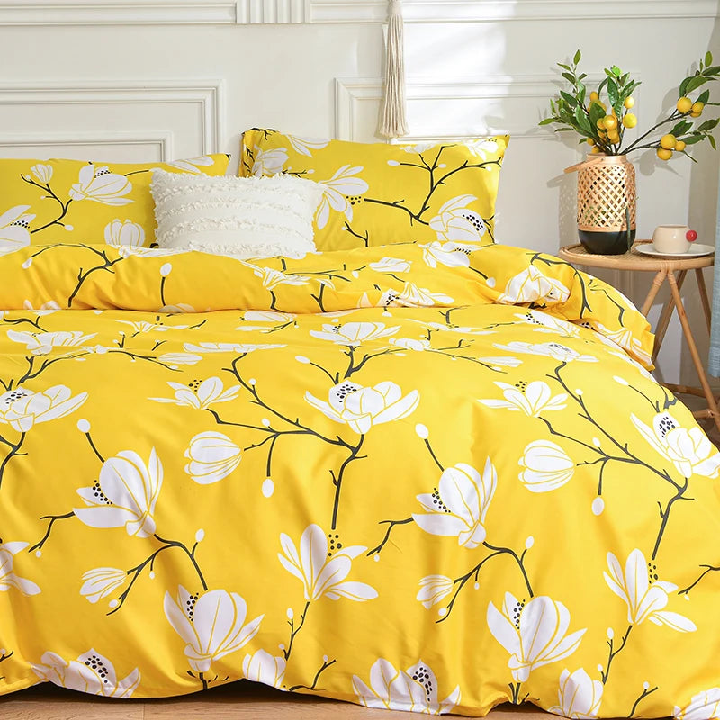 Yellow duvet cover set with a marble print floral pattern and white pillows on a bed.