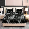 Black and white marble print fitted sheet set with pillowcases on a bed.