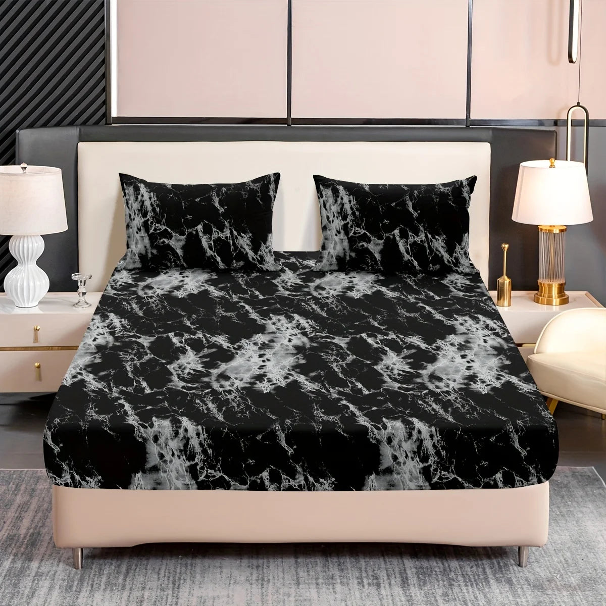 Black and white marble print fitted sheet set with pillowcases on a bed.