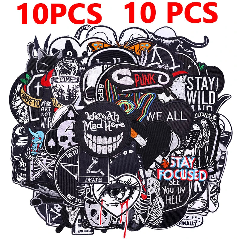 A pile of 10 embroidered punk patches featuring various symbols and text for DIY clothing.