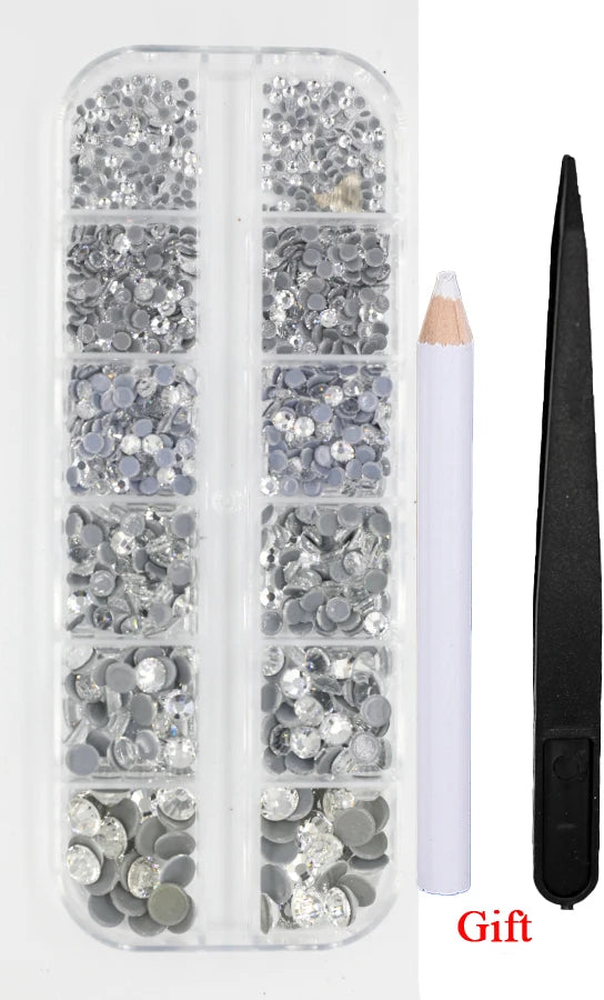 A clear plastic container holds various sizes and colors of crystal hot fix rhinestones and an applicator tool.