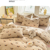 A beige duvet set featuring a light brown dog print pattern on the fabric, displayed on a bed with white pillows.